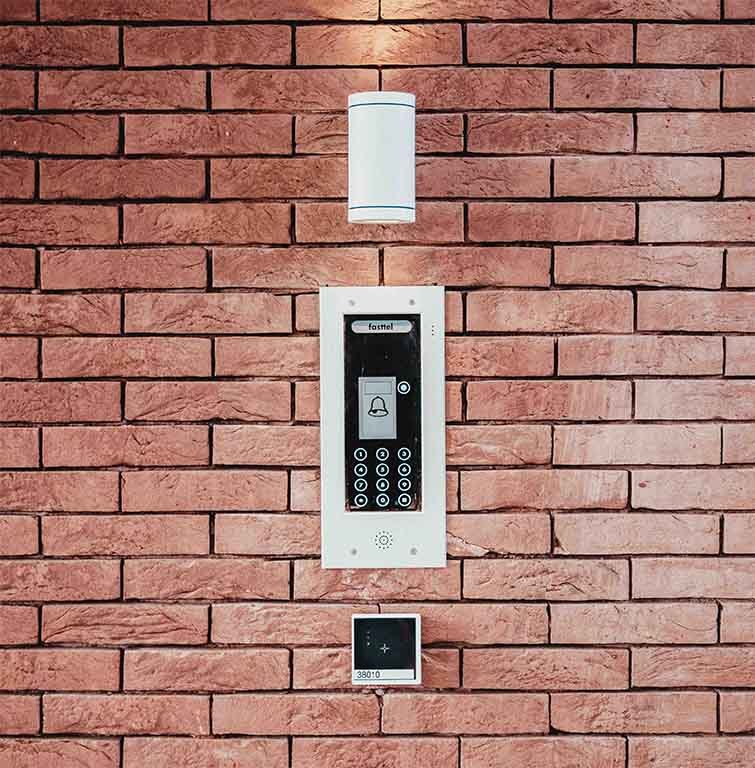This is an image of a Audio video intercom bell System on a brick wall