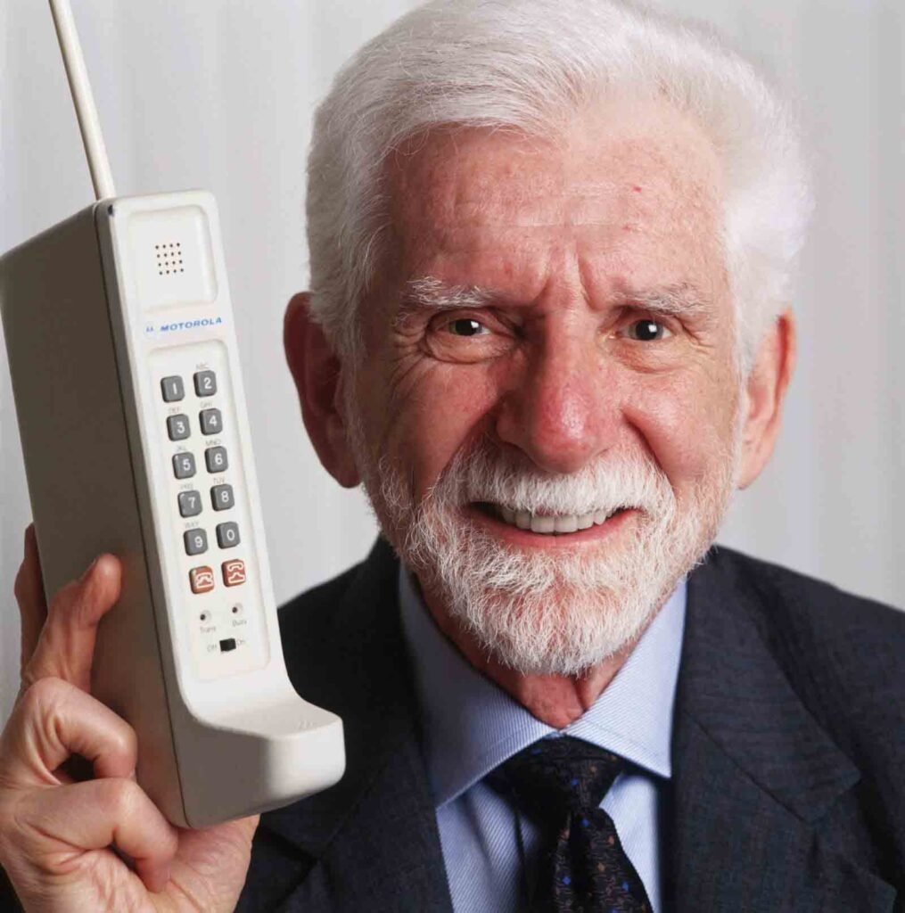Martin Coper hoding Motorola DynaTAC 8000X forst cell phnoe which he invented in 1973